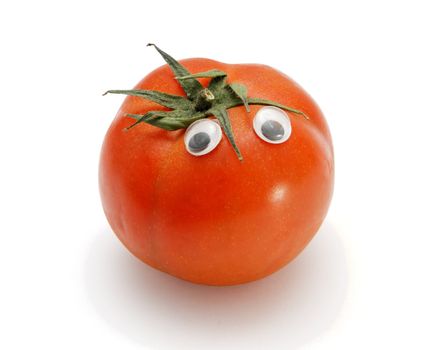 Funny red tomato with eyes on white background