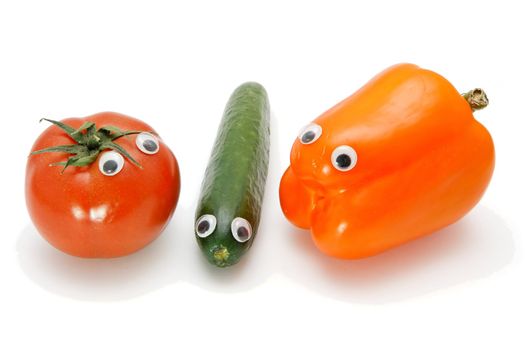 Funny tomato, cucumber and bellpepper with eyes on white background