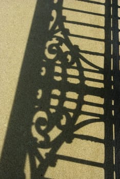 shadow of ornament rail on sidewalk