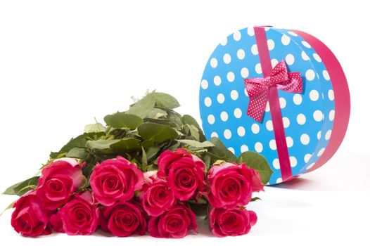 giftbox with pink roses in front isolated on white