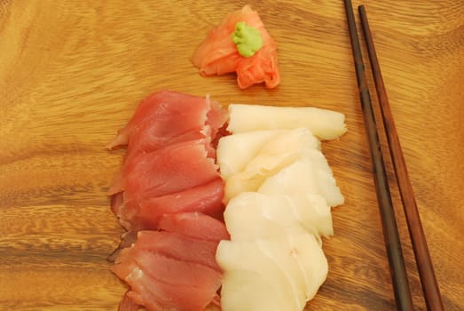 sushi meal with sashimi (tuna and bass) and chopsticks
