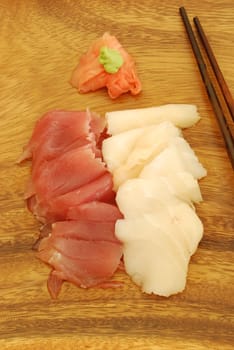 sushi meal with sashimi (tuna and bass) and chopsticks