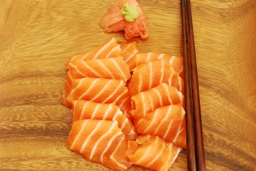 sushi meal with sashimi (salmon) and chopsticks