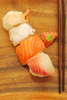 sushi meal with nigiris (salmon, swordfish, shrimp, octupus) and chopsticks