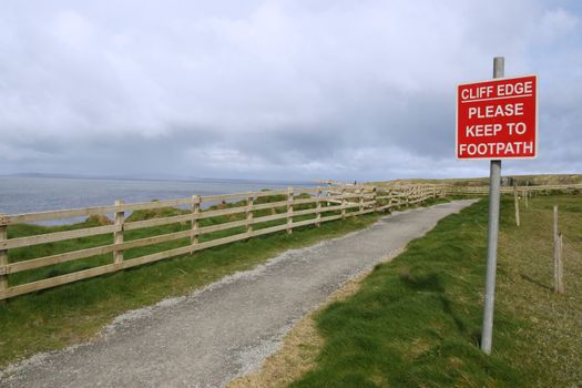 a warning sign of danger on the cliff edge walk in ballybunion