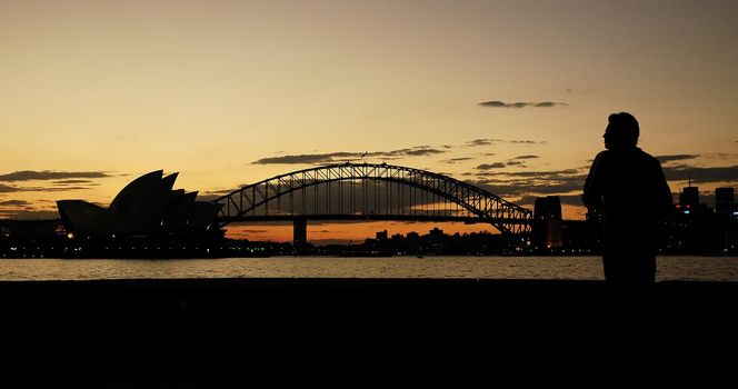 opera house, harbor bridge and a man silhouettes, dusk photo, Sydney, Australia