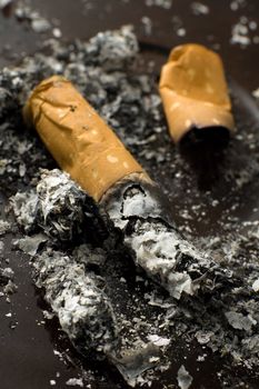 detail photo of cigarette butts and a lot of ash