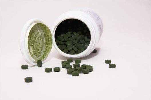 dose of green pills isolated on whte background