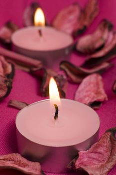 pink candles on violette decorated cloth, 