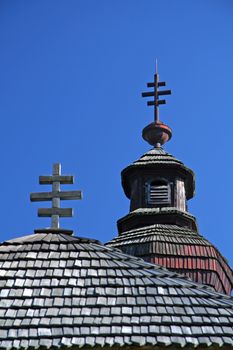 detail photo of an old wooden orthodox church with typical crosses, 