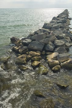 dike made of rocks on ocean shoreline