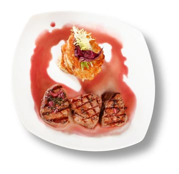 Veal Medallions with potato pancakes. Closeup. File includes clipping path for easy background removing