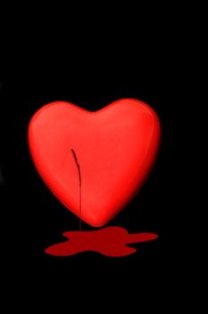 Bleeding Red heart isolated on a dark back ground