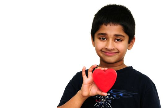 Handsome young Indian boy holding a red heart