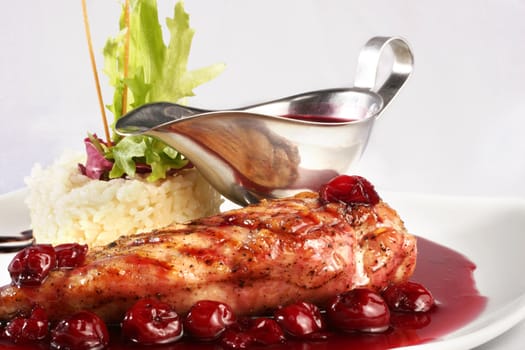 Chicken grill with rice and cherry sauce. Closeup