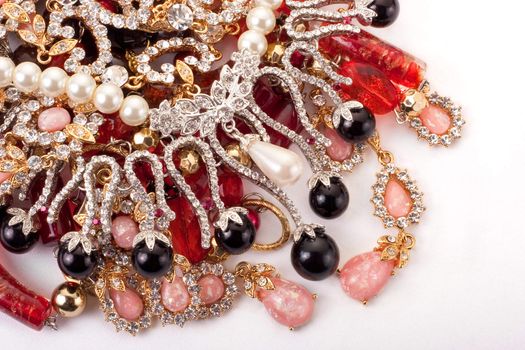 A pile of colored jewellery on white background