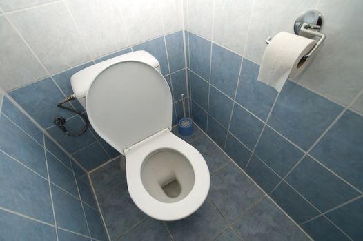 white toilet, tiles on floor and walls, 