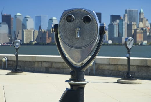 binoculars at jersey city, new yorks manhattan in distance