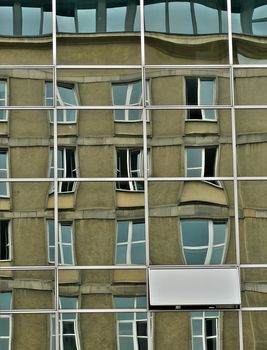 windows reflection on a glass building in Warsaw