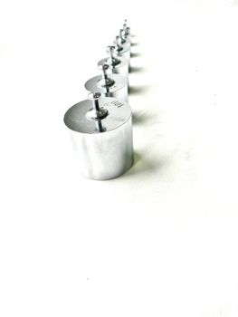 different sizes of small  weights lined up 