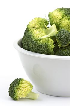 broccoli in a bowl on white background