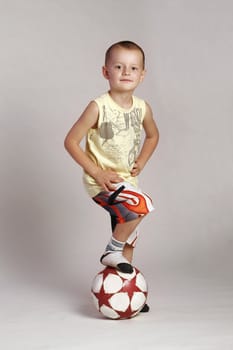 Kid keep his leag on a ball