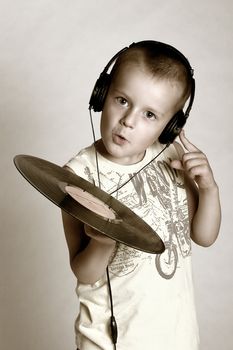 Child in headphones with grame playing dj