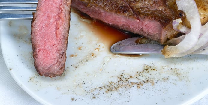 fresh juicy beef ribeye steak grilled,sliced on a plate