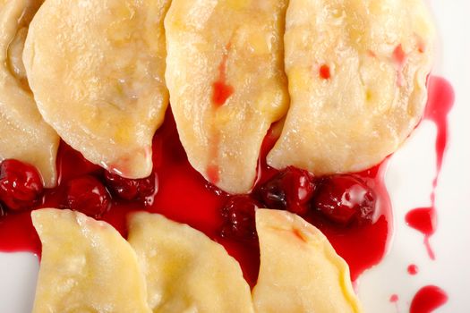 Ukrainian national dish varenyky (ravioli) with cherry closeup