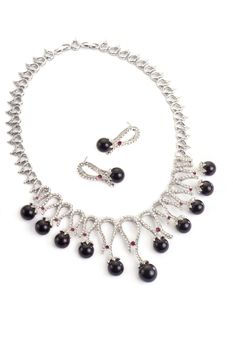 Necklace with black pearls on a white background