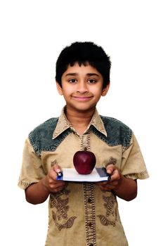 An handsome Indian kid holding apples with a smile