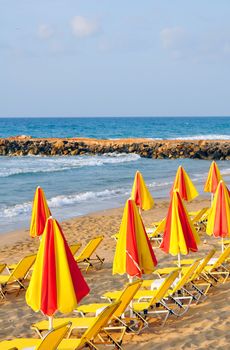 Travel photography: summer: sunbeds and umbrellas in mediterranean beach