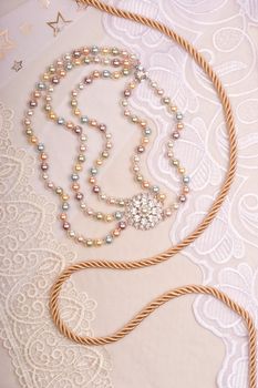 Chain and necklace on lace background