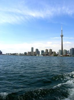 Toronto skyline. The group of buildings placed where the sky is meeting the water. 