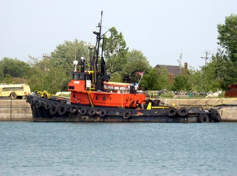 The Tugboat moored to the pier. On the exit of Welland canal a tugboat ready for emergency situations. 
