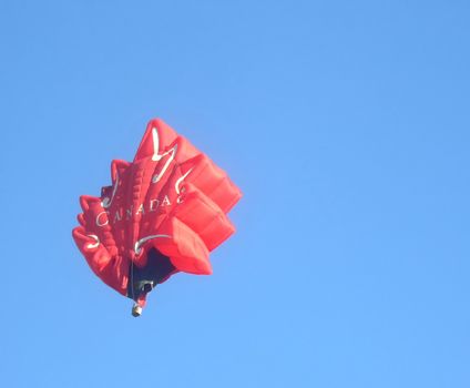 Hot air balloon shaped as maple leaf the symbol of Canada. London Balloon Festival August 2007. 
