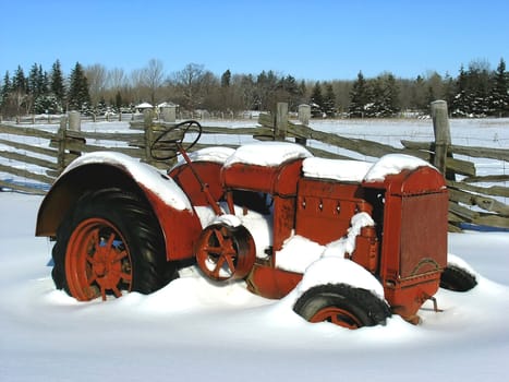 Old model agriculture machinery not longer in use during winter time. 