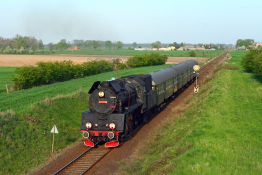 Steam retro train passing the countryside