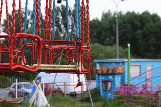 Seat of the chain carousel at the abandoned amusement park