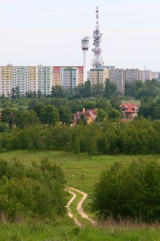 Bike trail with block of flats and radio towers in background