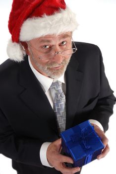 Senior Businessman with Christmas gift and Santa Claus hat.