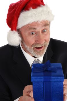 Senior Businessman with Christmas gift and Santa Claus hat.