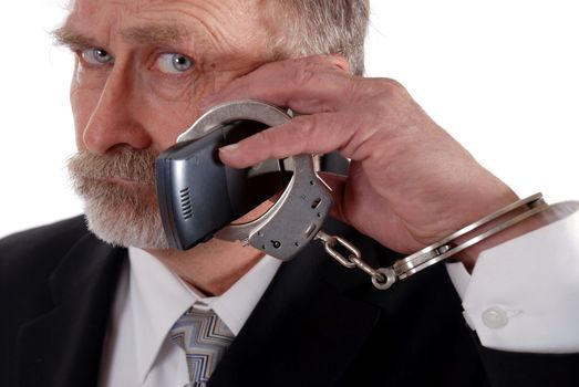 business man handcuffed to his cell phone