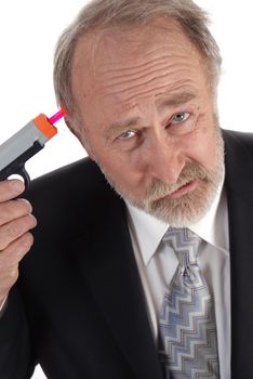 Businessman with a dart gun to his head looking sour. Poor business theme.