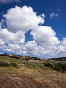 Beautiful sky and clouds over typical valley in Malta