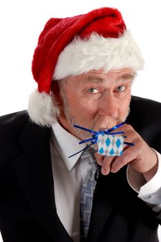 Business man in santa hat blowing party blower