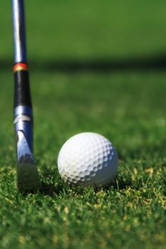 An Iron club preparing to hit a golf ball