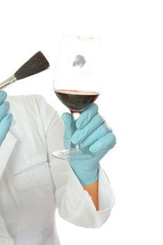 A forensic investigator or criminologist dusts a glass for fingerprints. Closeup on a white background.