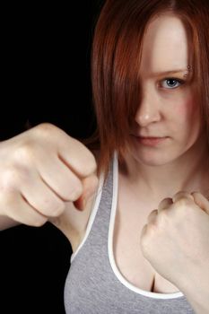 red haired teen girl doing a boxing workout