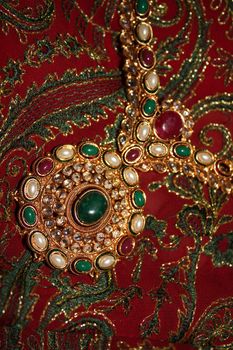 An antique jewelery set in traditional Indian design, studed with precious gemstones.